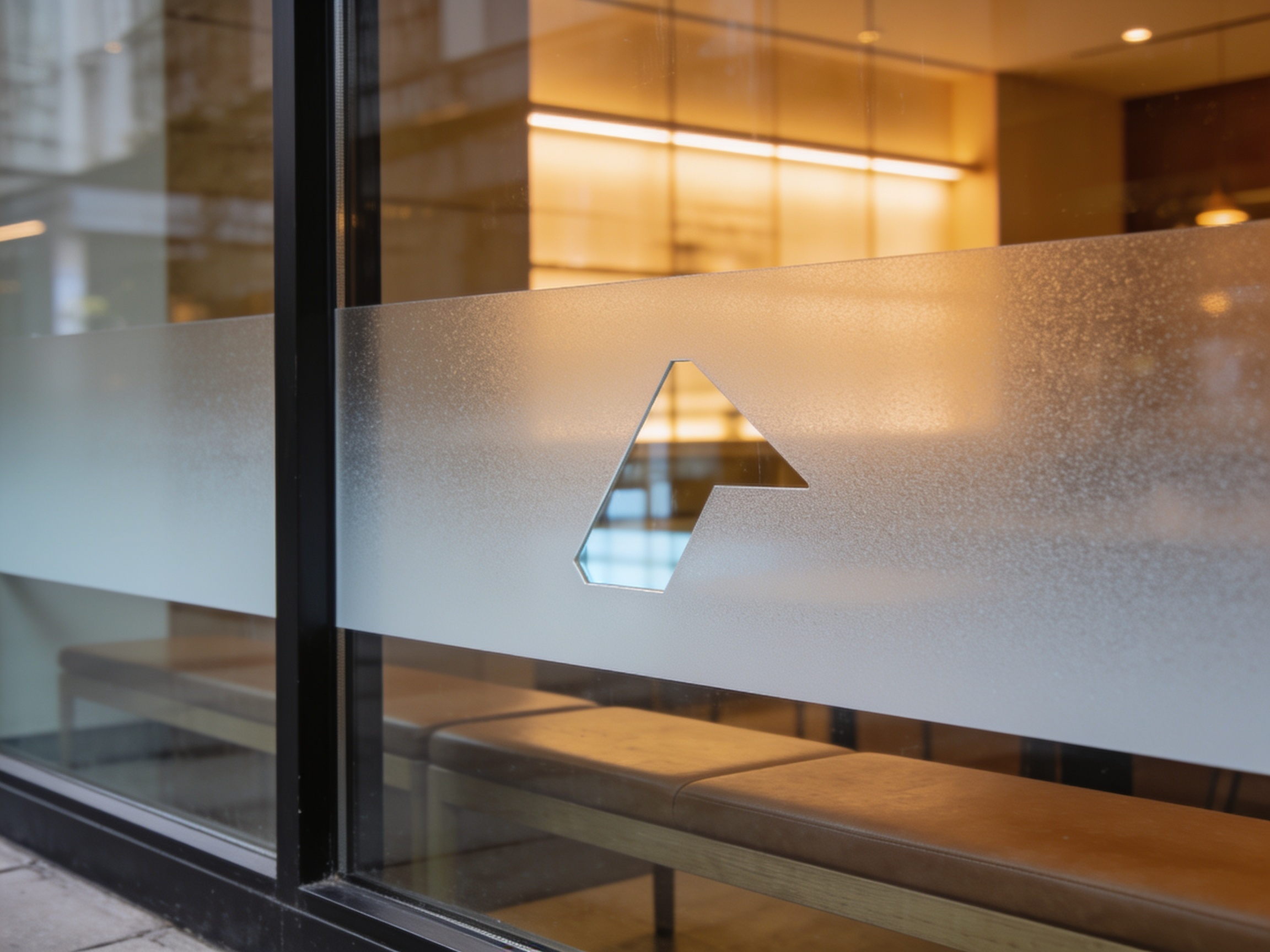 A band of frosted etch vinyl across storefront glass at seated height, with a shape cut out so clear glass shows through.